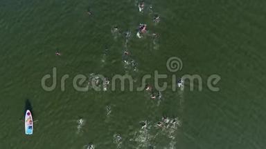 运动员在河上游泳比赛的高空向下，附近有救生艇